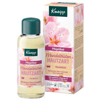 Kneipp Mandelblüten Hautzart hand care oil in a clear bottle with a dark green cap, shown next to its matching pink and beige floral packaging box on a white background.