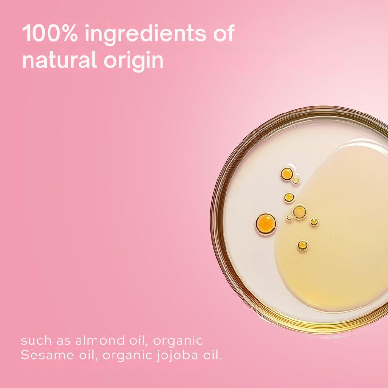 A pink promotional graphic with text reading '100% ingredients of natural origin' and 'such as almond oil, organic Sesame oil, organic jojoba oil.' A top-down close-up of a round clear container filled with pale yellow oil and a few golden droplets appears on the right side.