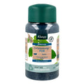 A bottle of Knipp Entspannung-PUR bath crystals with a dark green cap and a white label featuring green leaves and blue text, set against a plain white background.
