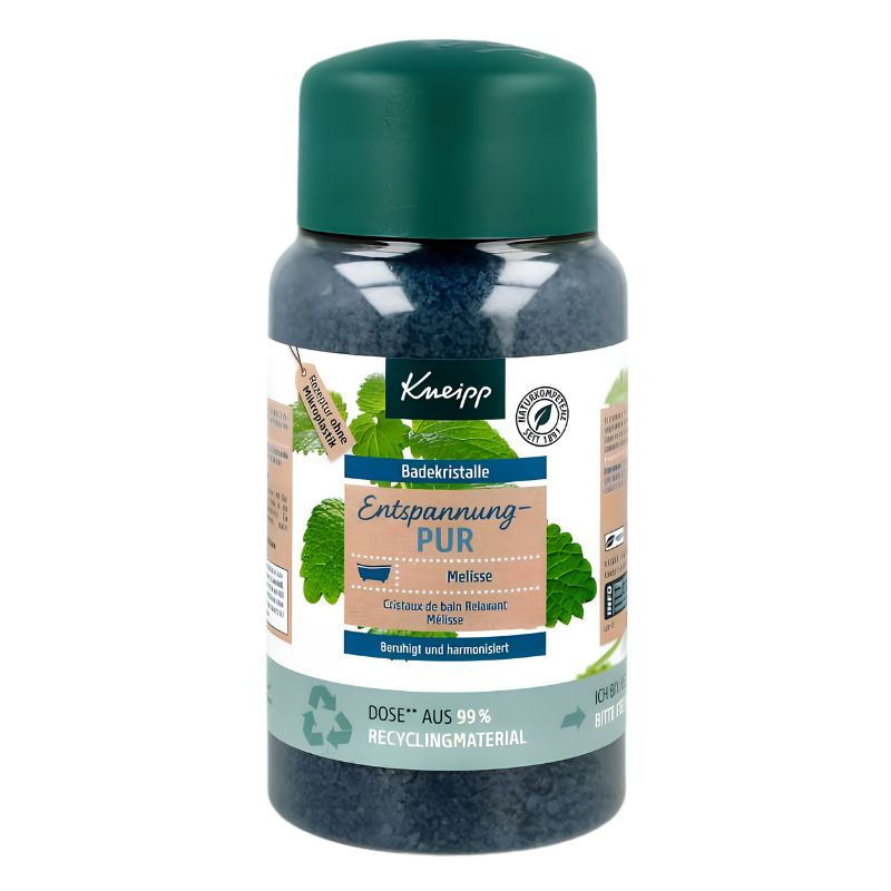 A bottle of Knipp Entspannung-PUR bath crystals with a dark green cap and a white label featuring green leaves and blue text, set against a plain white background.