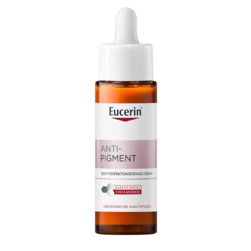 A bottle of Eucerin Anti-Pigment serum with an amber brown glass bottle, white dropper cap, and a white label with pink and red accents, isolated on a white background.