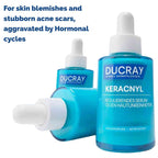 Three blue and white Ducray Keracnyl serum dropper bottles on a white background with blue promotional text at the top.