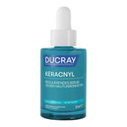 Ducray Keracnyl skincare serum in a 30 ml dropper bottle, featuring a teal blue glass container and a white dropper cap against a plain white background.