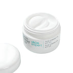 A white cosmetic jar of Paul Merier Skin Expert AHA Crème 5% with its lid placed beside it on a clean white background.