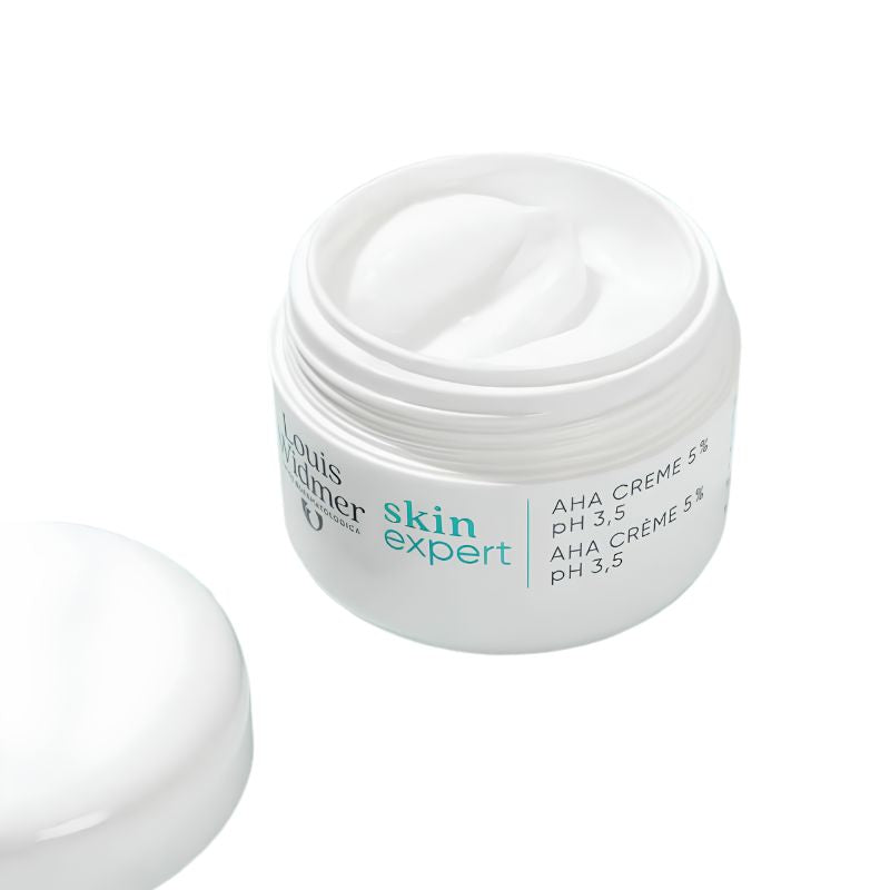 A white cosmetic jar of Paul Merier Skin Expert AHA Crème 5% with its lid placed beside it on a clean white background.