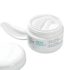 Louis Fer skin expert AHA creme intensive 10% pH 5.5 in a white jar with the cap off, showing a dollop of white cream inside and a separate smear of cream on the left, on a white background.