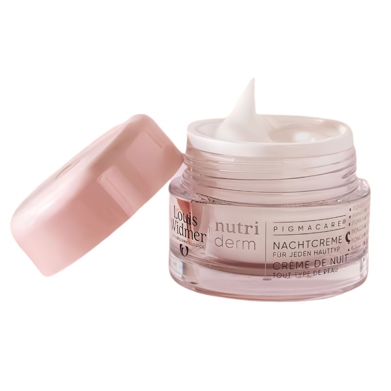 An open jar of Louis William Nutri Derm Pigmacarer night cream, showing the white cream inside, with its pink cap resting beside it on a white background.