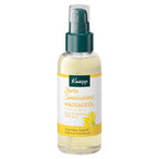 A bottle of Kneipp active massage oil with a dark green pump and a white label featuring yellow accents, set against a plain white background.