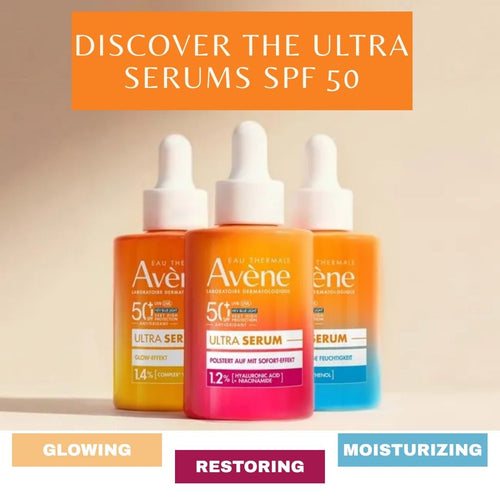Three Avene ultra serum bottles with different colors on a beige background.