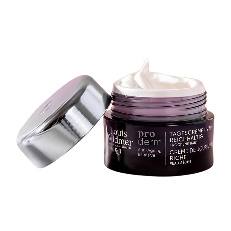 Louis Widmer pro derm Tagescreme UVP with perfume in a dark purple jar with a silver lid, showing a swirl of white cream inside, on a white background.