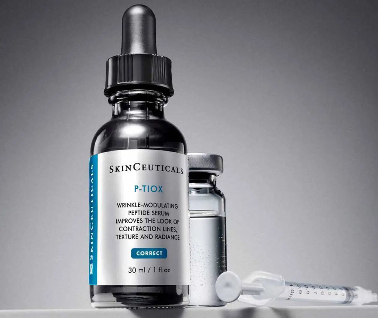 Skinceuticals P-Tiox bottle standing next to an injection needle to demonstrate that a combination of neurotoxin injectables and P-TIOX works synergistically to reduce wrinkles through multiple mechanisms, thereby reducing wrinkles in different areas of the face.