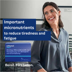 Women smmiling and the Orthomol package next to her. Vital F contains micronutrients to reduce tiredness and fatigue