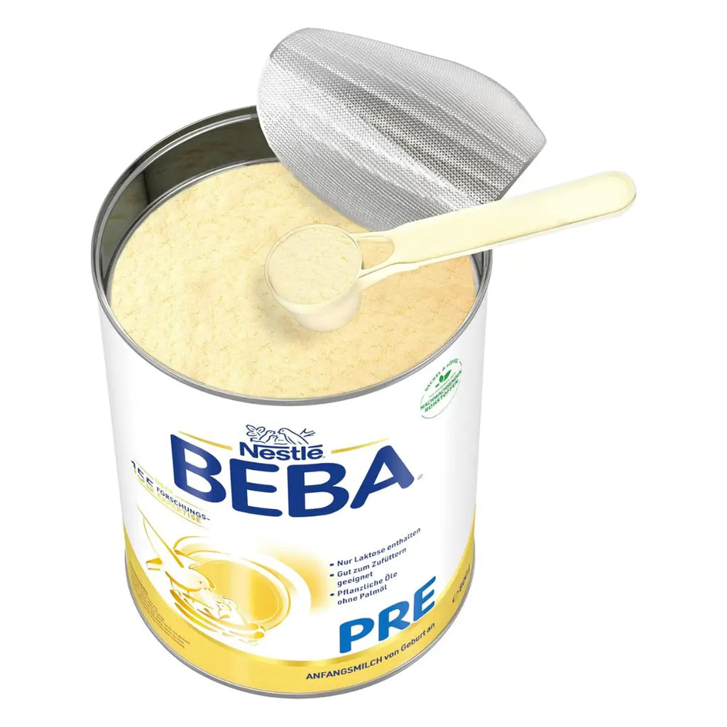 An opened Beba box with a measuring scoop in the milk powder