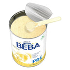 An opened Beba box with a measuring scoop in the milk powder