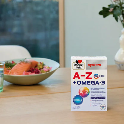 A package of Doppelherz A-Z Omega-3 capsules on the dining table with a plate of salmon and salad in the background