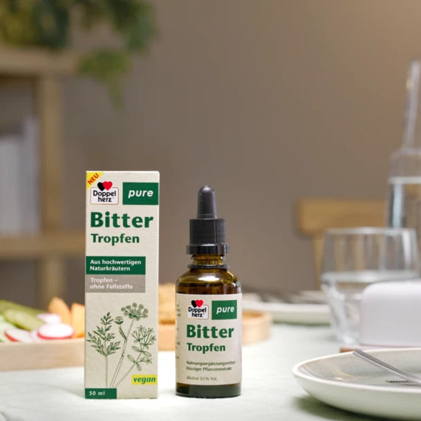The typical consumption situation: a bottle of Doppelherz bitter drops standing on a dinner table