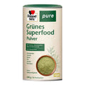 A 600g cylindrical container of Doppel herz Pure Grünes Superfood Pulver, featuring a beige label with green text and a photo of green powder in a bowl.